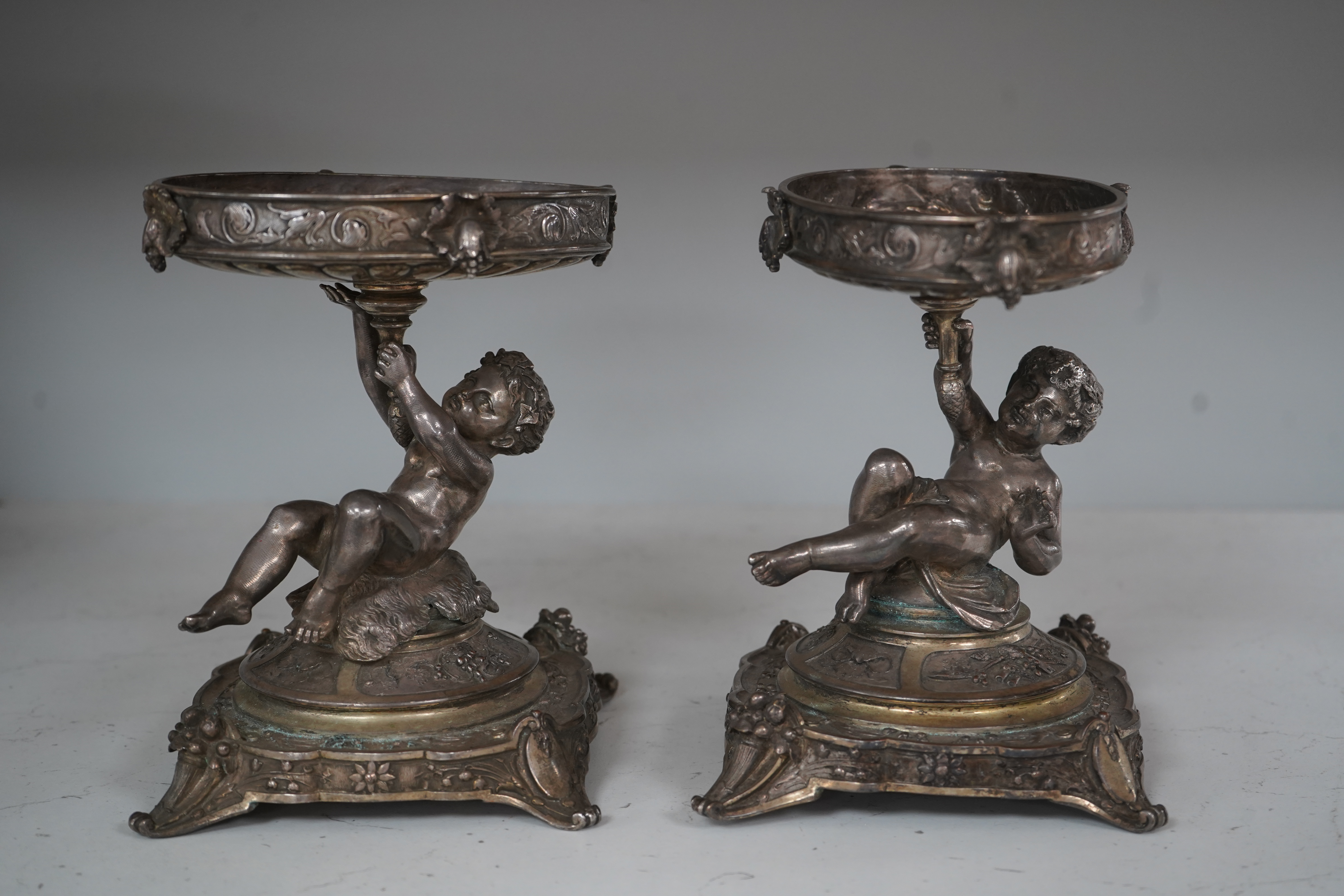 A pair of Victorian Elkington & Co. silver plated ‘putti’ stands, 17cm. Condition - fair to good